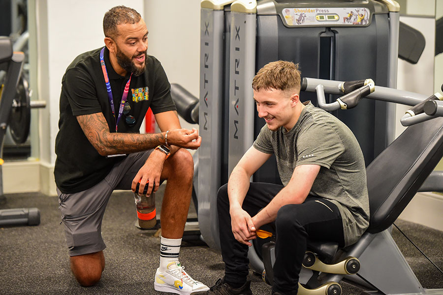 Trevor works in a gym mentoring a young person