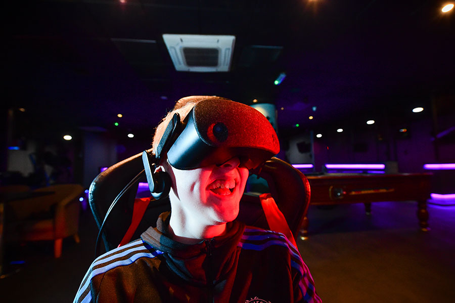 Young person enjoys a mentoring session at a VR arcade