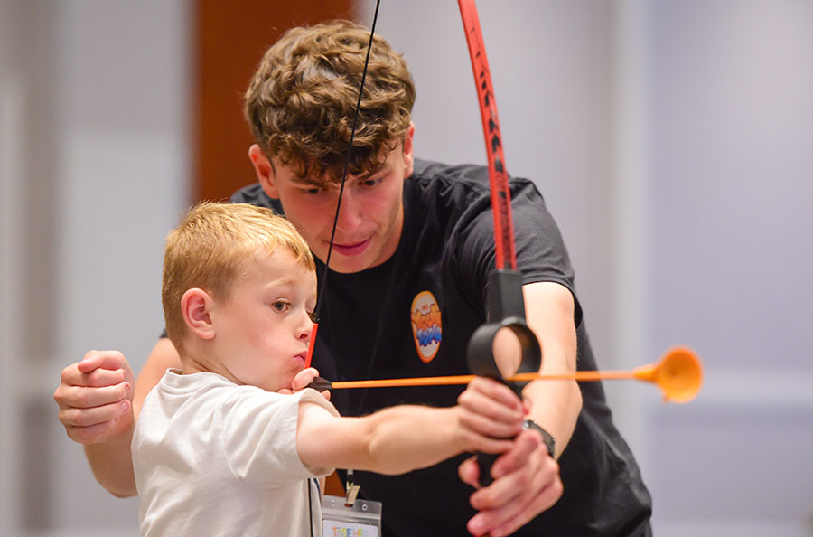 Young person enjoys a archery at TWMAD's Youthtopia.
